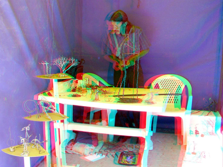 a toy doll table and chair is pictured