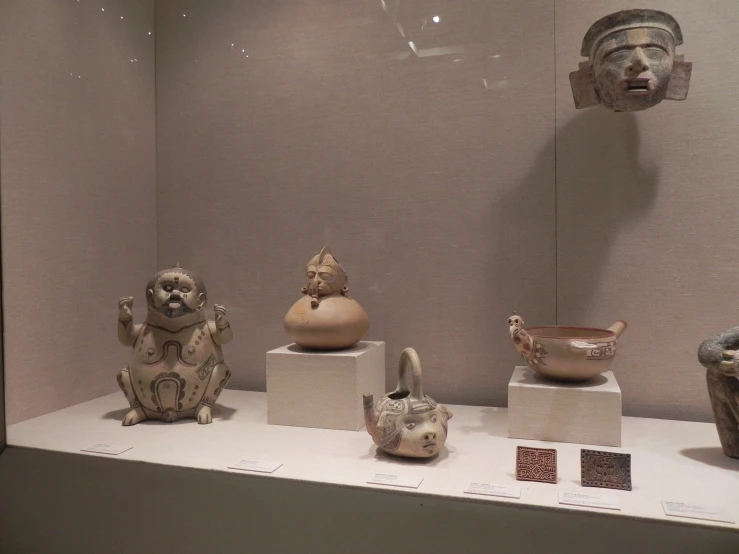 various pottery sculptures on display on the wall