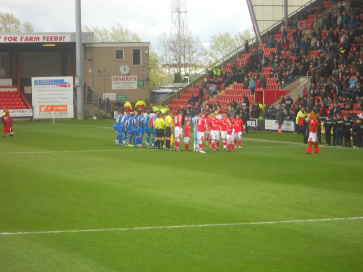 a football team in bright colors standing on a field