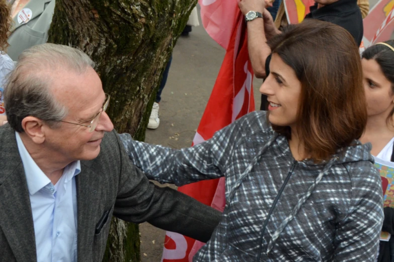 two people, one smiling, are being pographed