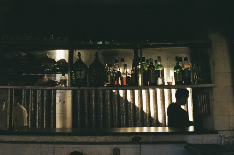 a kitchen with several bottles of liquor behind the counter