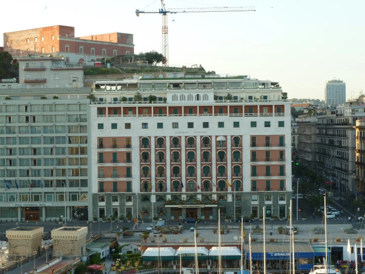 a large building and other city buildings and a crane