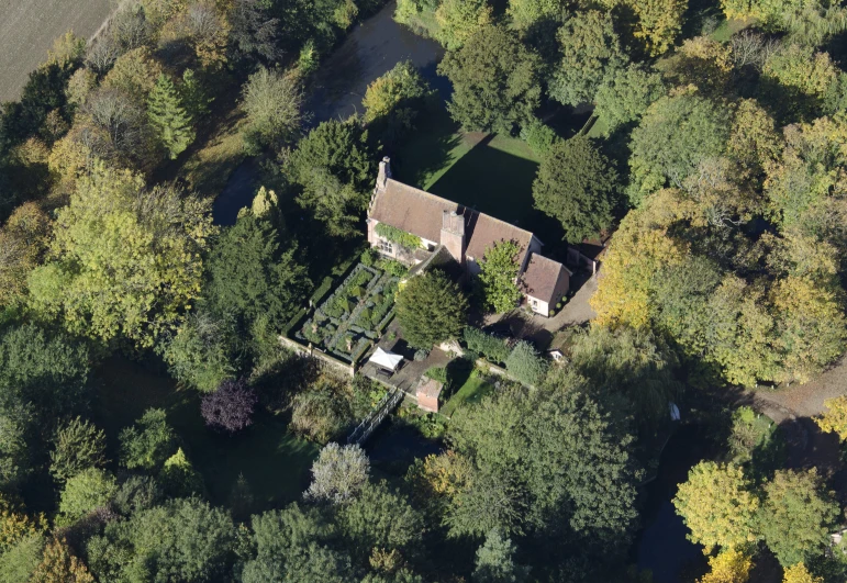 an aerial po of a large house in the woods