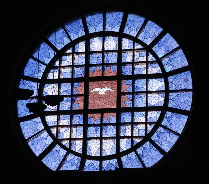 a stained glass circular window of blue and black colors