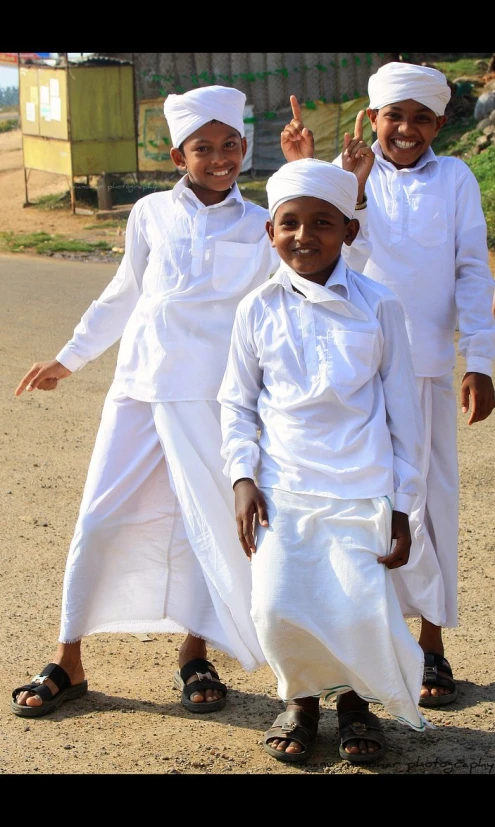 three young children in plain clothing posing for the camera