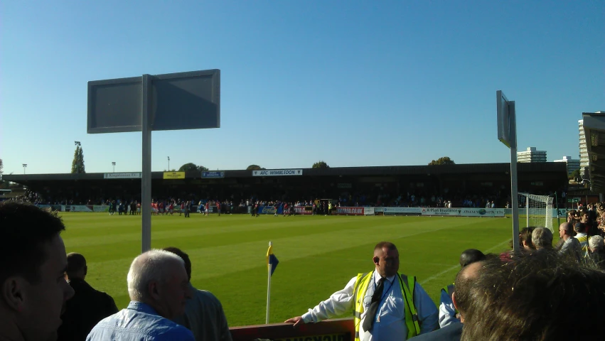 people are watching a sports game in a stadium