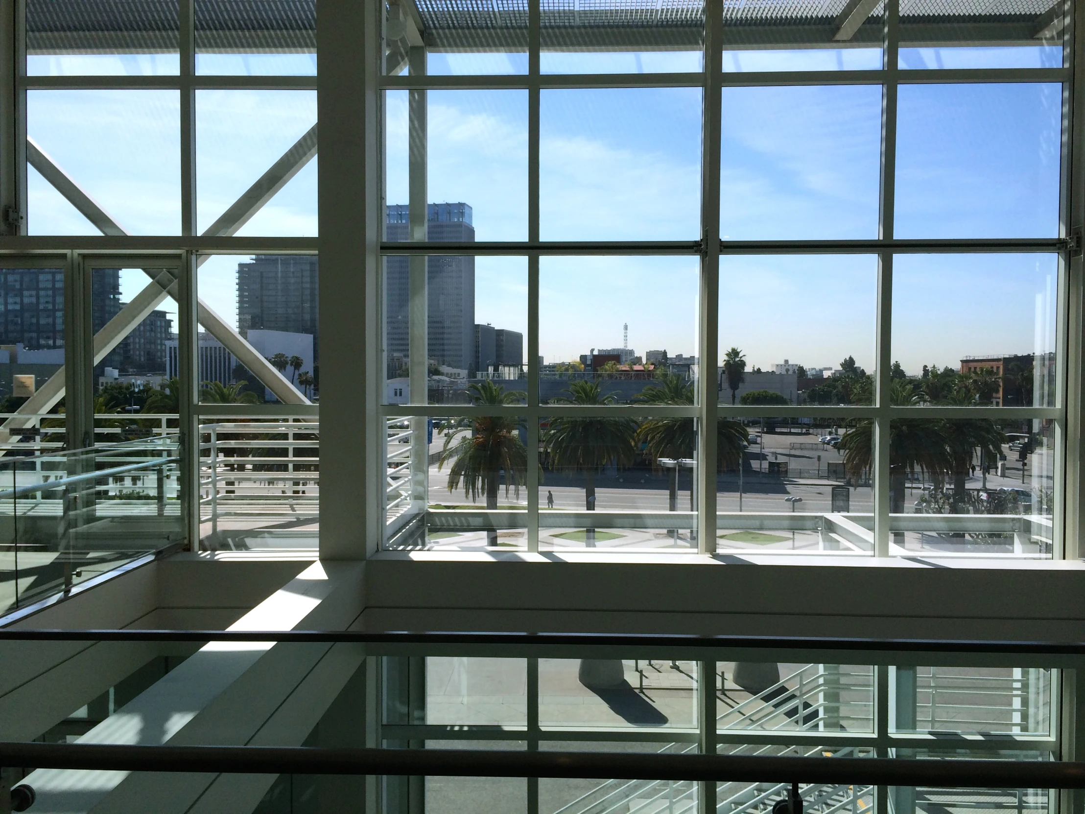 a window view of a parking lot, the city is seen through