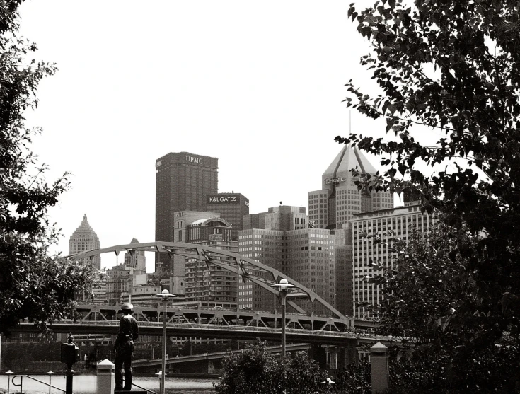 a man is standing near the city with his skateboard