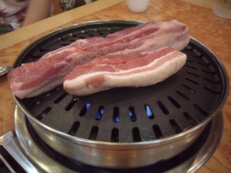 pork on a large grill on a wood table