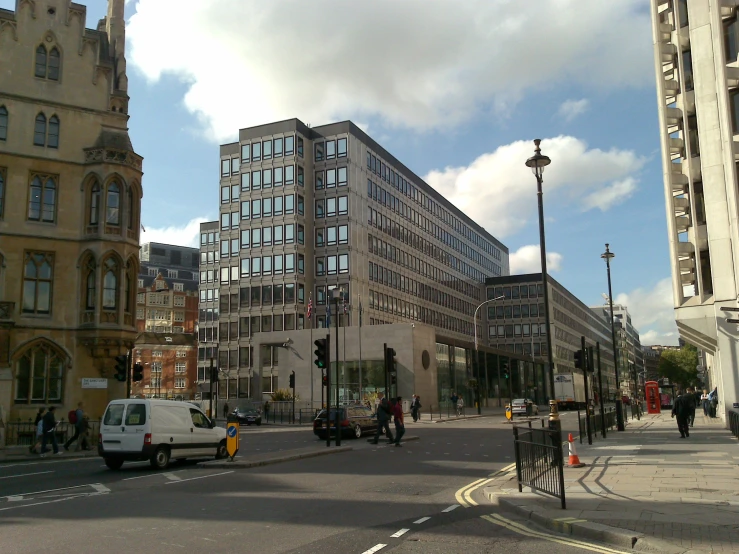 there are cars, bikes, and pedestrians on the street