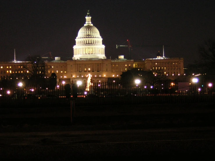 a large building lit up at night in the dark