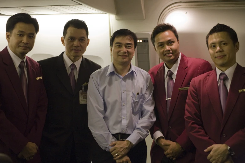 four young men are posing for the camera