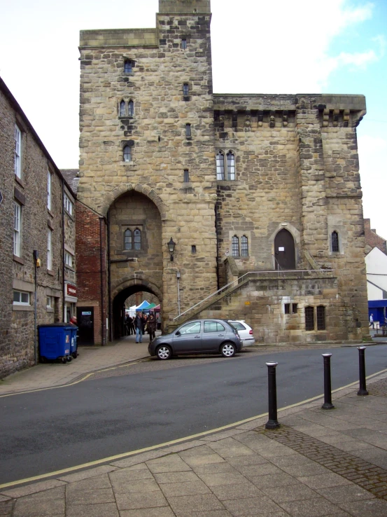 cars parked in front of old, old brick buildings