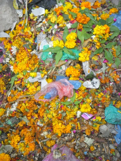 a large pile of flowers and trash on the ground