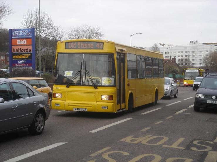 a yellow bus is traveling down the road