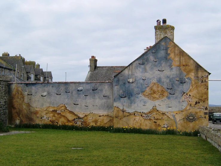 a house made out of rock with a painted face on the side