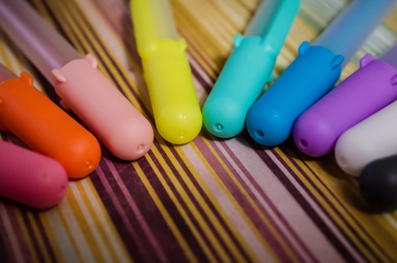 a set of four colored pens sitting next to each other