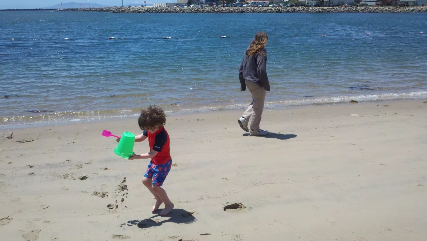 two children playing on the sand at the beach