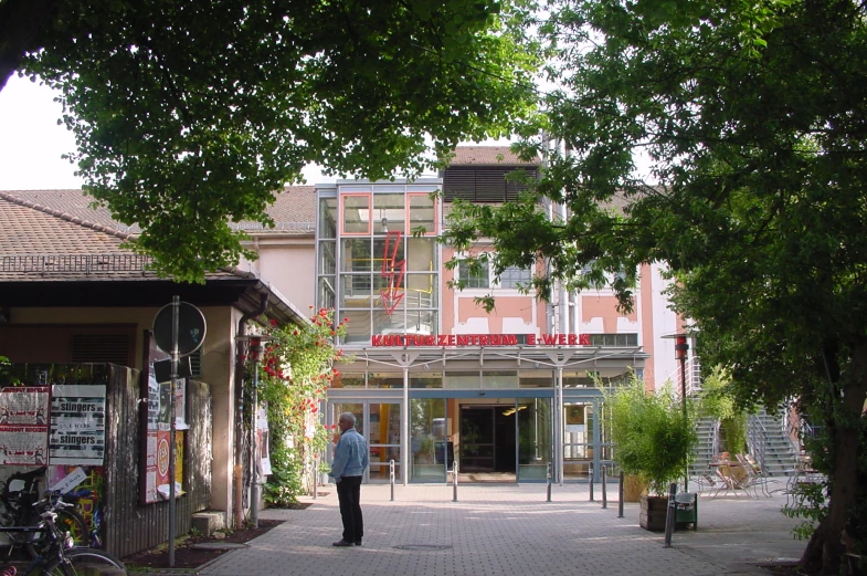 an elderly woman walking through the entrance to a shopping center