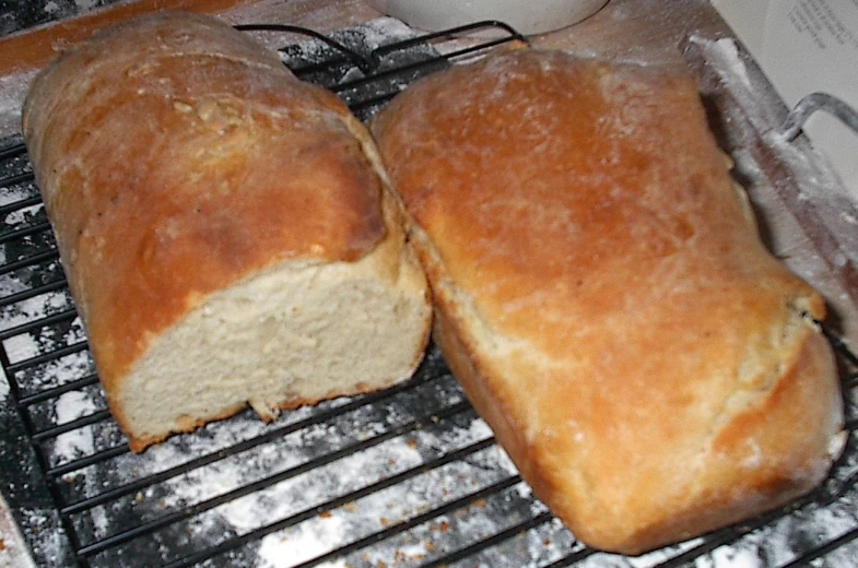 a large loaf of bread is sitting on a barbecue grill