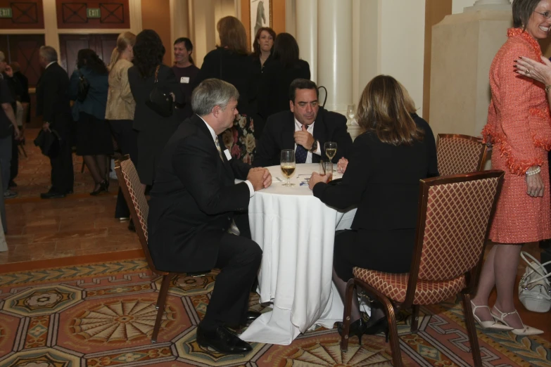 a couple and their guests at a fancy party