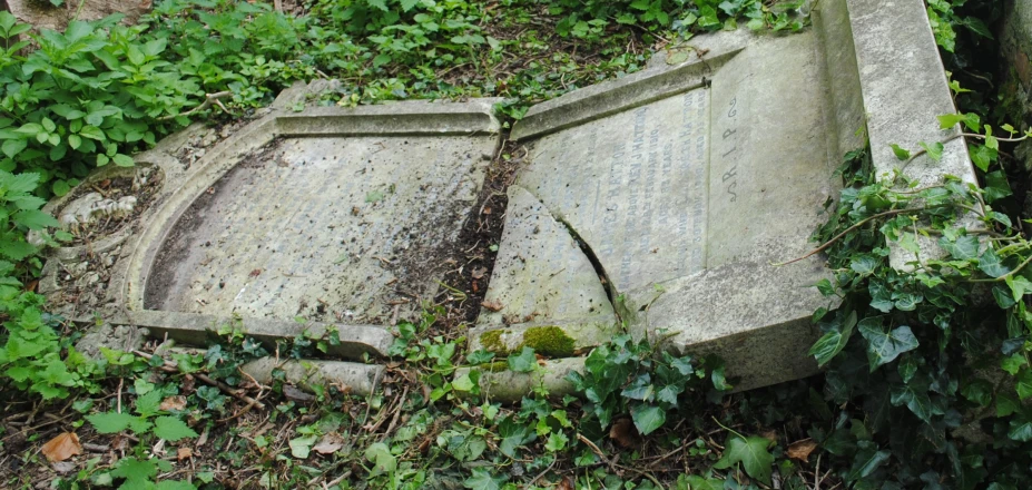 a very old tombstone with a large hole in it