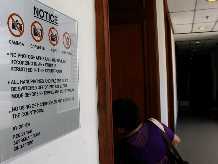 a person stands behind an entrance at the front of an office