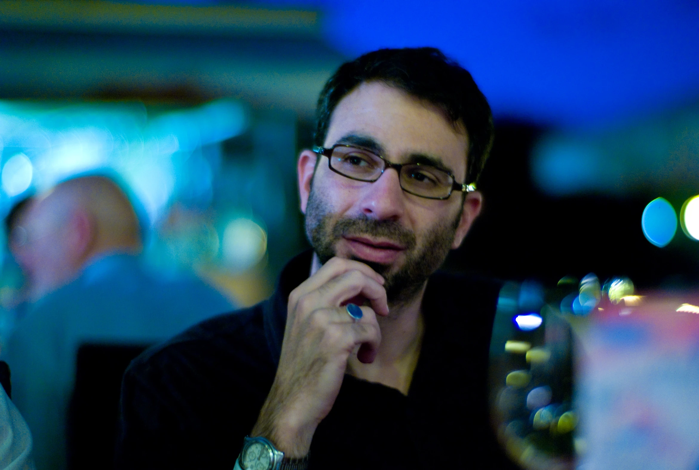 a man sits down with a glass in his hand