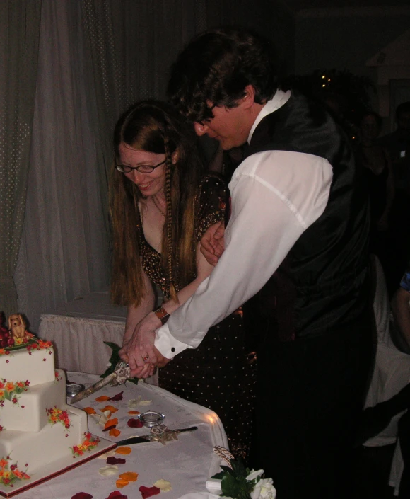 a man and woman  a wedding cake