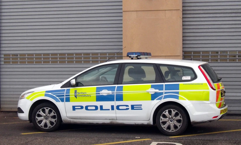 a police car parked next to a building