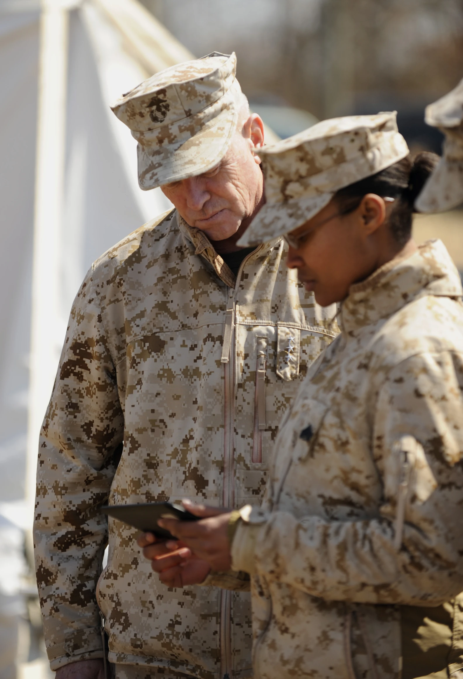 two army women standing close to each other