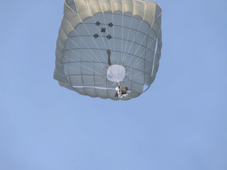 two people are attached to a para - sail flying high in the air