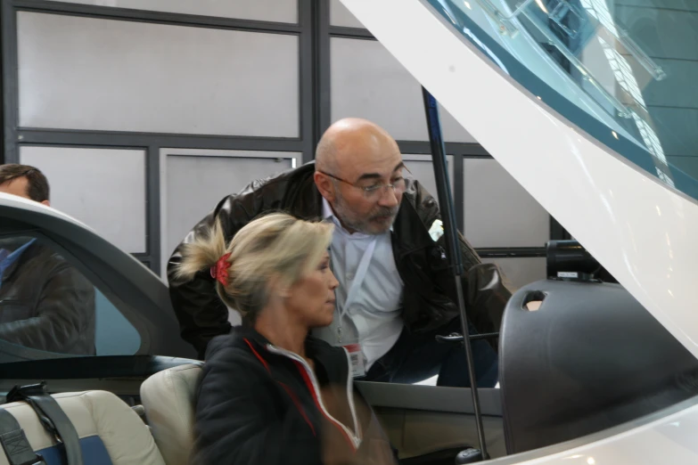 a man and woman standing next to each other in an airport