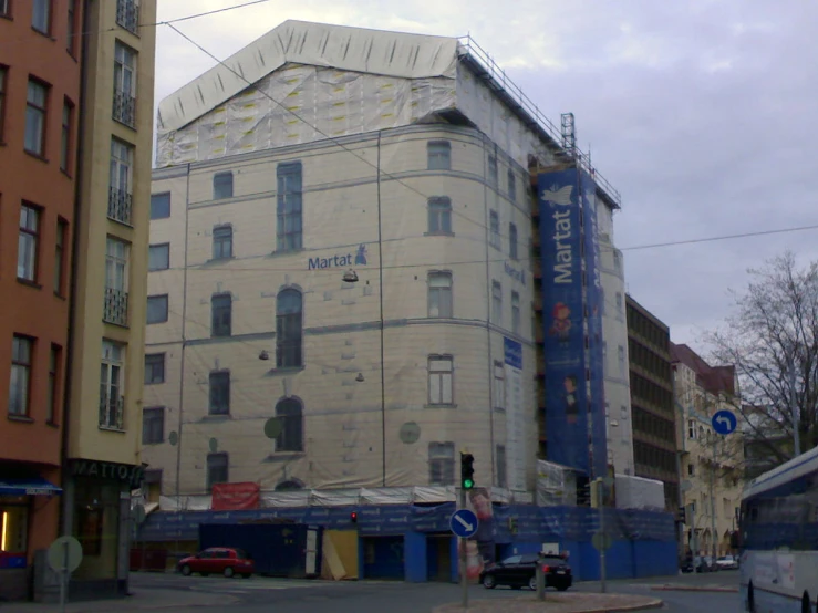 there is an old building on the corner of a city street