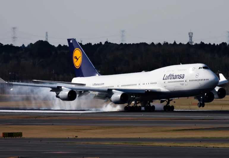 a large white and blue plane is on the runway