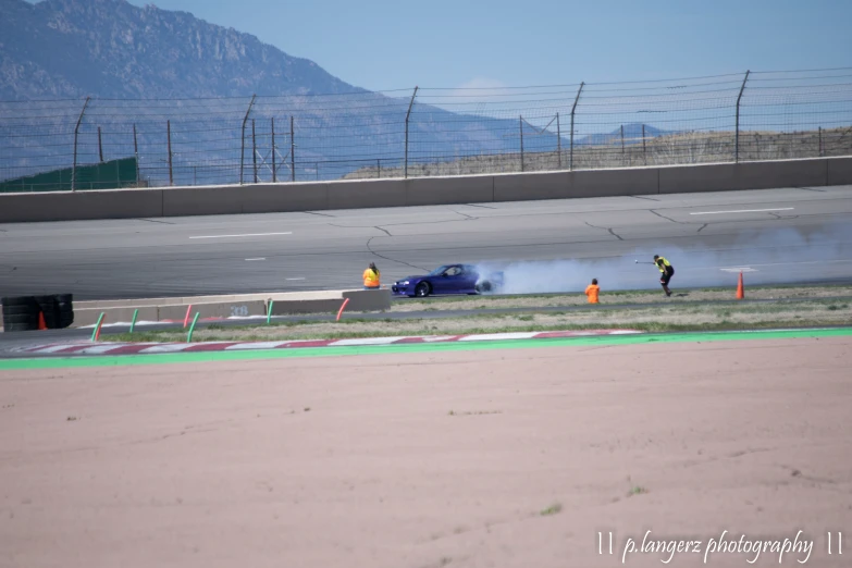 a car blows up smoke during a racing