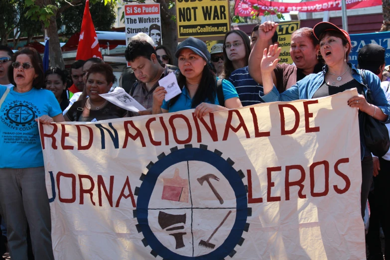 a group of people holding up a sign