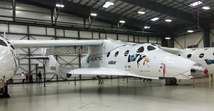 a white airplane with paint splattered on it is on display