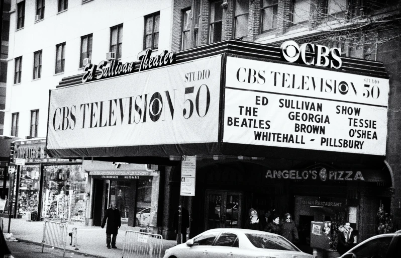 the sign for an italian cinema is on the side of the building