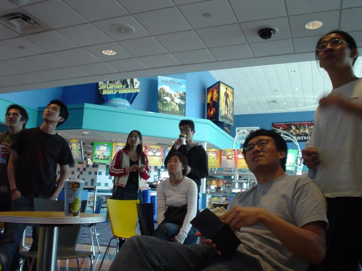 a group of young people playing wii games together