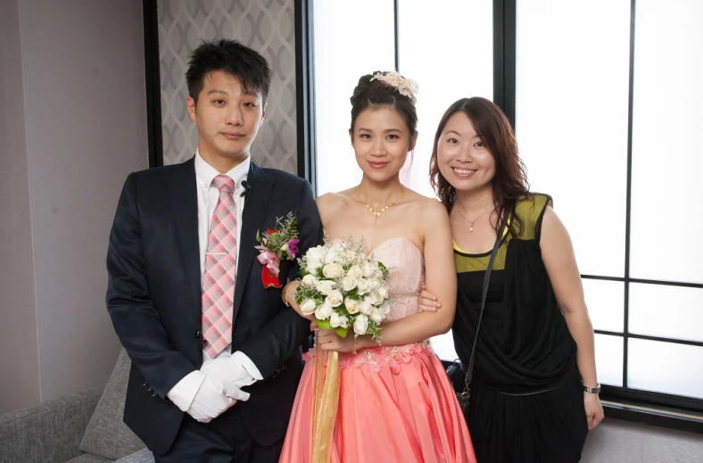 a woman posing for the camera with two men