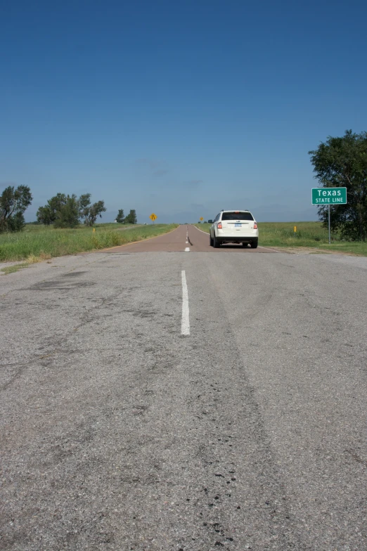 two vehicles are driving down the deserted road