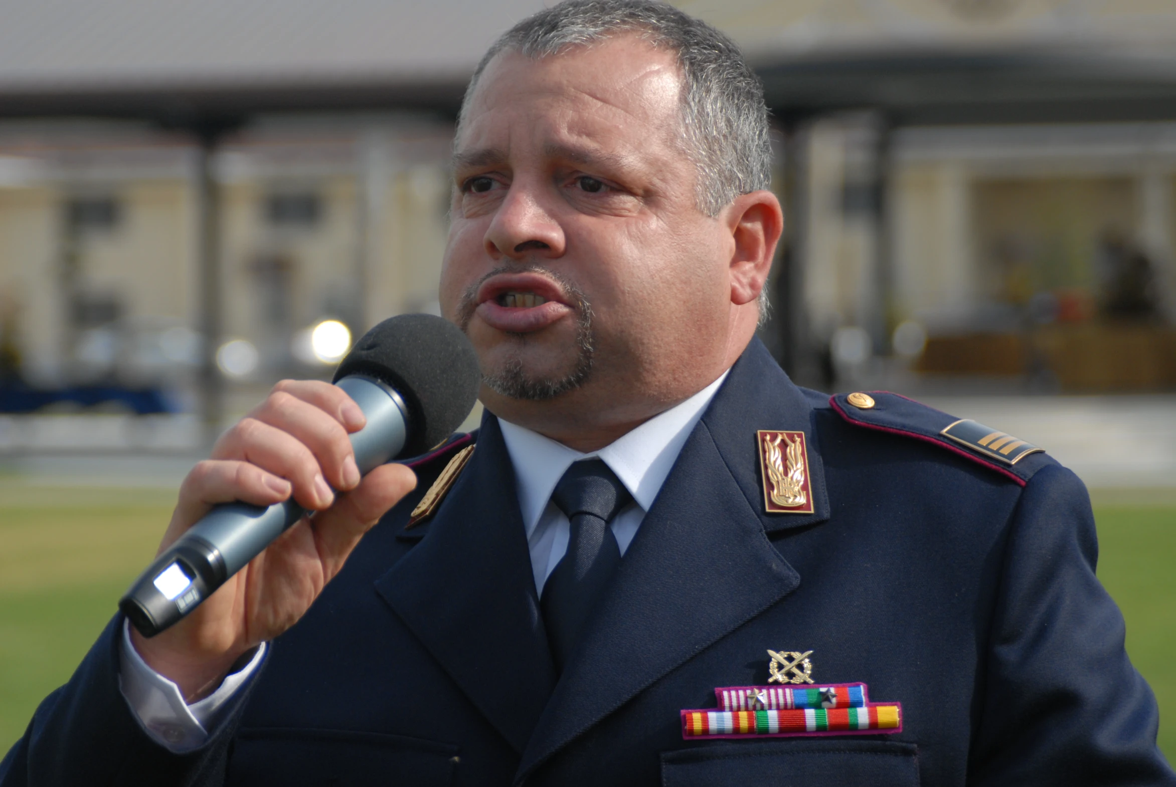 a person in uniform holding a microphone