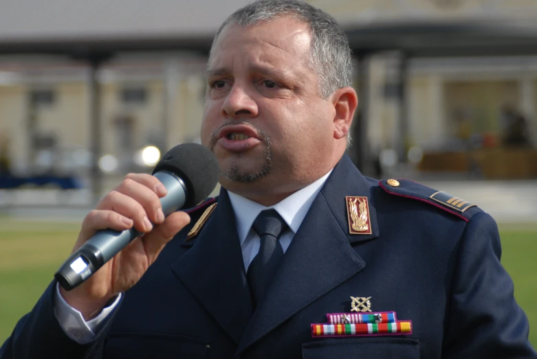 a person in uniform holding a microphone