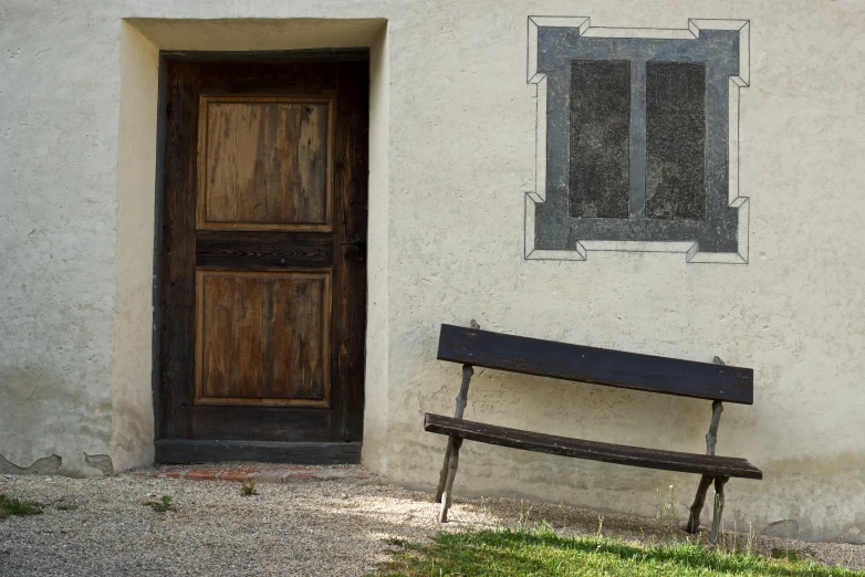 there is a bench outside of the house