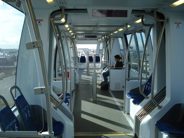 a person sitting inside of a bus in the day