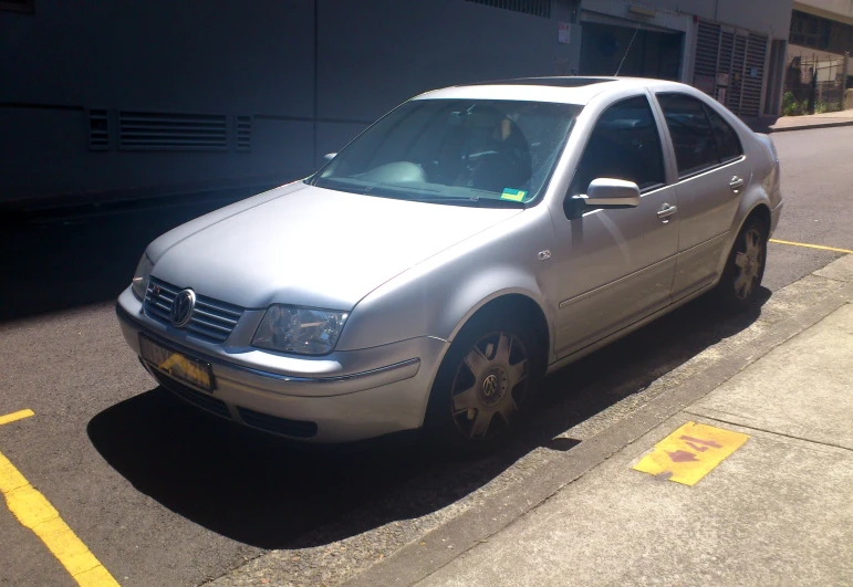 a white vehicle parked on the side of a street