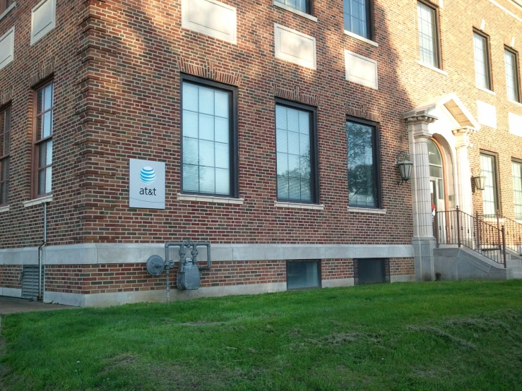 an old brick building with windows and a sign