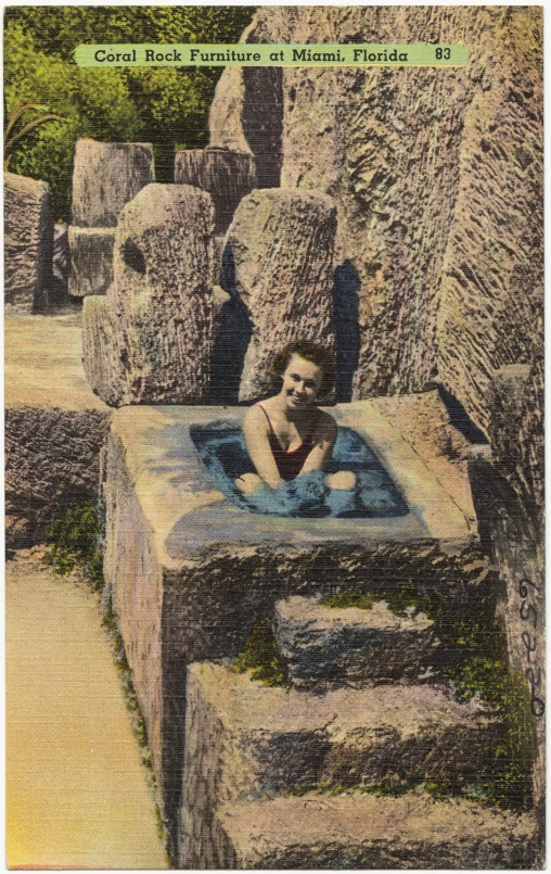 a man in a spa tub surrounded by elephant statues