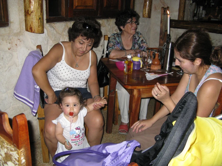 woman sitting on the floor while another sits next to her on the ground